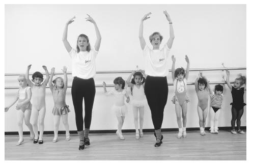 Young girls in a ballet dancing class. The instructors are serving as live models, showing the girls a behavior that they are to imitate and practice. This is an example of learning through modeling. (Bob Krist/CORBIS. Photo reproduced by permission.)