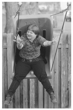 An adolescent swings on the playground at a respite care facility that provides short-term care for families who have children with developmental disabilities. (AP Photo/Fort Collins Coloradoan, Sherry Barber. Photo reproduced by permission.)
